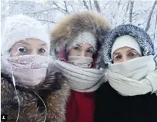  ?? ANASTASIA GRUZDEVA/SAKHALIFE.RU VIA THE ASSOCIATED PRESS ?? Anastasia Gruzdeva, left, and two friends put on a brave face in -50 C weather in the Yakutia region of Russia on Tuesday.