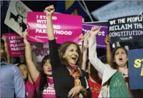  ?? THE ASSOCIATED PRESS ?? Neera Tanden, president, Center for American Progress, center, rallies in front of the Supreme Court in Washington on Monday after President Donald Trump announced Judge Brett Kavanaugh as his Supreme Court nominee.