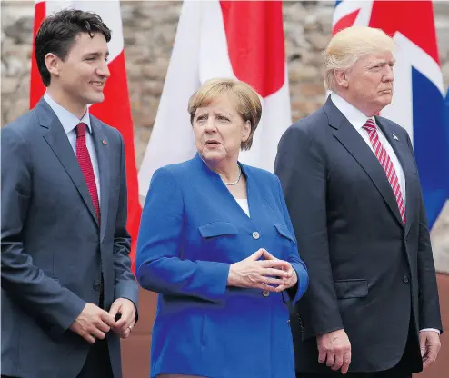  ?? MANDEL NGAN / AFP / GETTY IMAGES ?? Prime Minister Justin Trudeau, German Chancellor Angela Merkel and U. S. President Donald Trump at the G7 Summit on Friday. Trump and other leaders are said to be far apart on issues like climate change and free trade.