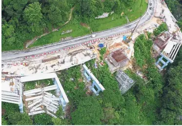 ??  ?? Precarious position: An aerial view of the collapsed area where the concrete beams fell in Jalan Tun Sardon near Jalan Paya Terubong.