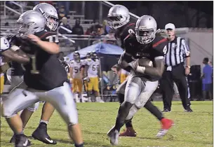  ?? Kevin Myrick / Standard Journal ?? Running back Tony Mathis finds an open route and heads for a first down during Friday’s game.