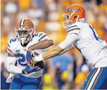  ?? WADE PAYNE/AP ?? UF running back Lamical Perine, left, is eager to snap the Gators’ losing streak against rival Florida State.