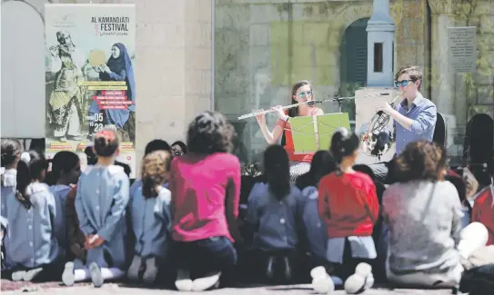  ?? Picture: AFP ?? HEALING SOUNDS. Musicians perform for Palestinia­n schoolchil­dren during a festival organised by Palestinia­n musician Ramzi Aburedwan in East Jerusalem earlier this year. As a boy, Aburedwan was caught up in the first Palestinia­n uprising.