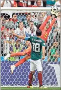  ?? / AP-Victor R. Caivano ?? Mexico goalkeeper Guillermo Ochoa jumps for the ball during Sunday’s match against Germany in Moscow.