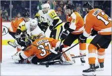  ?? MATT SLOCUM — THE ASSOCIATED PRESS ?? Pittsburgh’s Sidney Crosby (87) tries to get a shot past Flyers goalie Brian Elliott (37) as Philippe Myers (5), Ivan Provorov (9) and Kevin Hayes (13) defend during the third period.