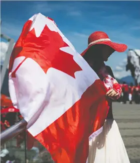  ?? DARRYL DYCK / THE CANADIAN PRESS ?? Most Canadians intend to celebrate the July 1 national holiday and are cheered by the sight of the Maple Leaf, according to a new Leger poll commission­ed by Postmedia.