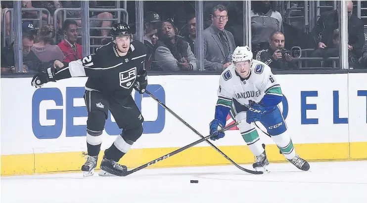  ?? — NHLI VIA GETTY IMAGES ?? The Canucks’ Brock Boeser and the Kings’ Nick Shore race for the puck Saturday during Vancouver’s 4-3 overtime win at Staples Center in Los Angeles.