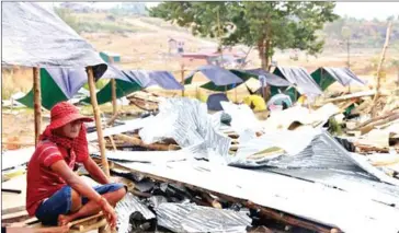  ?? PHA LINA ?? A man sits among demolished shelters in Preah Sihanouk province’s Prey Nop district.