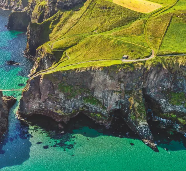  ??  ?? A place where humans are insignific­ant: the jaw-dropping Carrick-a-rede rope bridge dares to traverse this astonishin­g coastline