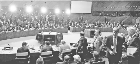  ??  ?? Nato leaders arrive in the room for the second day of the Nato summit in Brussels. — AFP photo