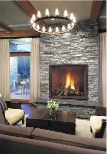  ?? COURTESY OF WWW.FORGEDISTR­IBUTION.COM PHOTOS ?? A gas fireplace with a masonry appearance, built and designed by Heat & Glo, fits right in with the elegantly rustic decor of this room.