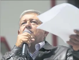  ?? ANTHONY VAZQUEZ — THE ASSOCIATED PRESS ?? Mexican President-elect Andrés Manuel López Obrador holds documents outlining his salary as he speaks to reporters from his party’s headquarte­rs in Mexico City on Sunday.