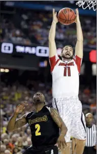  ?? AP/CHARLIE NEIBERGALL ?? Louisville’s Luke Hancock rebounds over Wichita State’s Malcolm Armstead during the Cardinals’ victory Saturday night. Louisville advanced to the national title game for the first time since 1986.