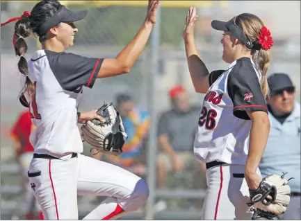  ?? Katharine Lotze/The Signal (See additional photos on signalscv.com) ?? (Above) Hart’s Jordyn Gasper, left, high-fives teammate Abby Sweet after defeating Paraclete in a CIF-Southern Section playoff softball game at Hart on Tuesday. (Below) Hart’s Brooke Marquez slides into third base safely during a game at Hart on Tuesday.