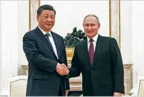  ?? RUSSIAN PRESIDENTI­AL PRESS OFFICE VIA THE ASSOCIATED PRESS ?? Russian President Vladimir Putin, right, and Chinese President Xi Jinping shake hands Monday at the Kremlin in Moscow.