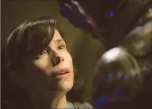  ??  ?? Sally Hawkins as Elisa Esposito and Doug Jones as the creature