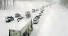  ?? CALTRANS VIA AP ?? A video image from a traffic camera shows vehicles stopped along snow-covered Interstate 80 at Donner Summit in the Sierra Nevadas.