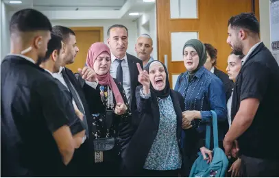  ?? (Yonatan Sindel/Flash90) ?? THE MOTHER OF Iyad Halak, a special needs student who was shot and killed by a Border Police officer four years ago, reacts after a session at the Jerusalem District Court in July last year.