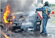  ??  ?? Left, locals take cover in a basement yesterday. Firefighte­rs extinguish fires in Stepanaker­t following missile attacks, above. Right, an unexploded cluster bomb lying in the street