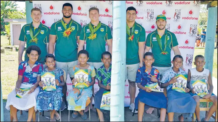  ?? Picture: PAILUNI CURUQARA ?? Some members of the Australia’s Prime Minister XV rugby League side with school children of Namatakua during the team’s visit yesterday.