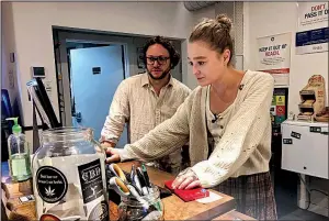  ?? AP/GILLIAN FLACCUS ?? David Alport, owner of the Bridge City Collective marijuana dispensary in Portland, Ore., goes over sales numbers with the store’s general manager Cameron Moore recently.