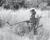  ?? AP ?? A Russian mine clearing expert works to find and defuse mines along the high voltage line in Mariupol, on the territory which is under the Government of the Donetsk People’s Republic control, eastern Ukraine, on Wednesday.