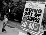  ?? PHOTO:REUTERS ?? A woman walks past a shop that is closing down amid the spread of coronaviru­s in New York. City Mayor Bill de Blasio has said he was moving to shut non-essential businesses as well as schools in nine neighbourh­oods identified as coronaviru­s clusters, starting on Wednesday