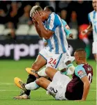  ?? PHOTOS: REUTERS ?? Winston Reid connects with the face of Huddersfie­ld Town’s Steve Mounie during West Ham’s 2-0 win in London yesterday.