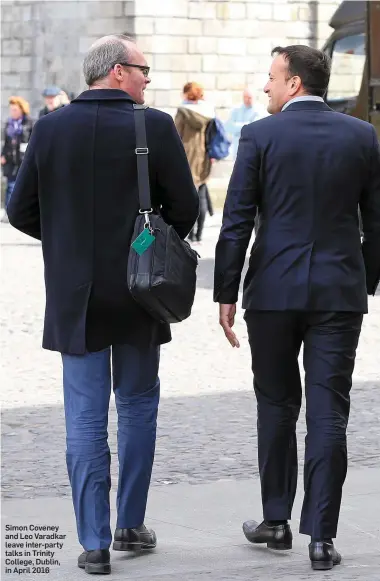  ??  ?? Simon Coveney and Leo Varadkar leave inter-party talks in Trinity College, Dublin, in April 2016