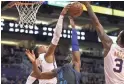  ??  ?? Phoenix Suns' Richaun Holmes blocks the shot by Dallas Mavericks' Harrison Barnes during a game on Dec. 13 at Talking Stick Resort Arena.