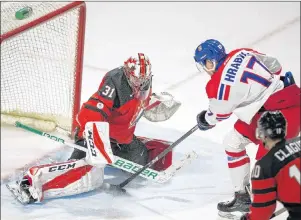  ?? CP PHOTO ?? The Czech Republic’s Krystof Hrabik tries to put the puck past Canada’s goalie Carter Hart during the third period in their World Junior Championsh­ips pre-tournament game in London Ont. on Wednesday.