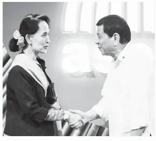  ?? (Pool photo) ?? MYANMAR State Counselor and Foreign Minister Aung San Suu Kyi shakes hands with President Duterte before the opening ceremony of the 31st Associatio­n of Southeast Asian Nations Summit in Pasay City.