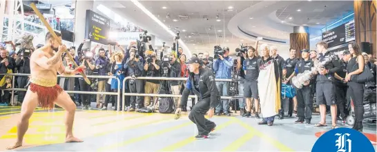  ?? Picture / Michael Craig ?? Team NZ chief Grant Dalton is welcomed by a member of Ngati Whatua at Auckland Airport.