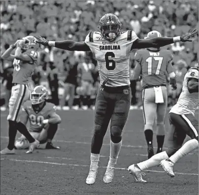  ?? KEVIN C. COX/GETTY ?? Sotuh Carolina linebacker T.J. Brunson reacts after Georgia’s Rodrigo Blankenshi­p missed a field goal in the second overtime on Saturday.