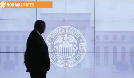  ?? — Reuters ?? A man overlooks an emblem for the US Federal Reserve System in Washington.