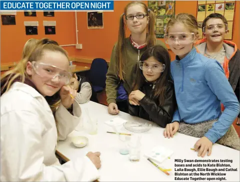  ??  ?? Milly Swan demonstrat­es testing bases and acids to Kate Bishton, Laila Baugh, Ellie Baugh and Cathal Bishton at the North Wicklow Educate Together open night. EDUCATE TOGETHER OPEN NIGHT