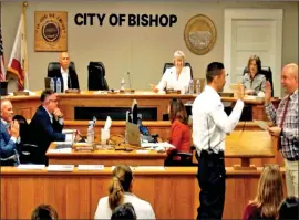  ?? Photo courtesy of the city of Bishop ?? Bret Russell, left, is sworn in by Bishop Mayor Jim Ellis Monday in front of the Bishop City Council, his family and members of the public. Russell was the fire chief for the city of Beckwourth, California, before coming to Bishop.