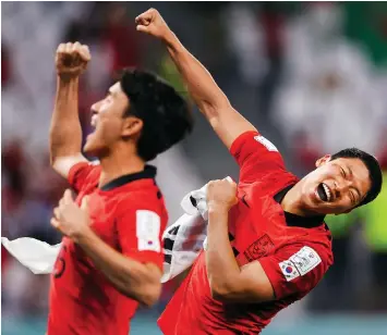  ?? Photo: Reuters ?? Match-winner Hwang Hee-chan and Hwang In-beom celebrate after South Korea qualify for the knockout stages.