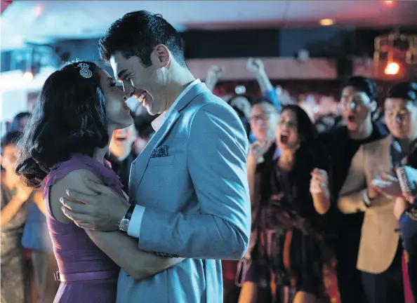  ?? WARNER BROS. ?? Constance Wu, left, and Henry Golding star as young lovers Rachel and Nick in Crazy Rich Asians, a simple rom-com that carries a lot of complicate­d expectatio­ns.