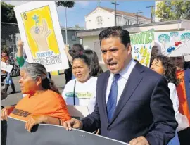  ?? Mark Boster Los Angeles Times ?? COUNCILMAN Jose Huizar joins parents and community members during a rally in Boyle Heights to support the Clean Up Green Up anti-pollution measure.