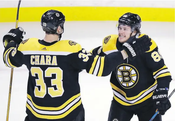  ?? — THE ASSOCIATED PRESS ?? Bruins winger David Pastrnak celebrates his goal with defenceman Zdeno Chara during the first period of their 4-1 win in Boston Wednesday over the Montreal Canadiens. The teams play for a third time in just over a week Saturday in Montreal.