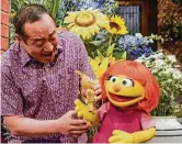  ?? Sesame Workshop ?? Alan Muraoka and Julia, a new Muppet character who has autism, play together on “Sesame Street.” Julia makes her debut April 10.