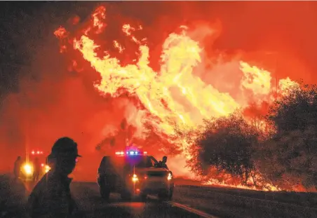  ?? Josh Edelson / AFP / Getty Images ?? Flames from the deadly North Complex Fire roar into Oroville on Sept. 9, threatenin­g remote Butte County communitie­s.