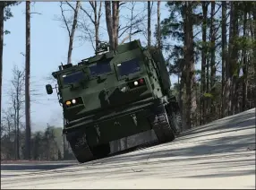  ?? (Arkansas Democrat-Gazette/Colin Murphey) ?? An M270 vehicle drives on an incline on the test track at the Lockheed Martin Camden Operations facility in Camden on Monday.