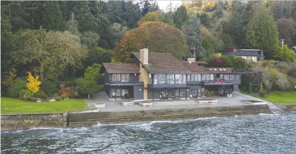  ?? PHOTOS: ROBERT BRITTINGHA­M ?? This stunning home on Vashon Island in Washington is accessible only by ferry or private boat. The boat house will accommodat­e a 60-foot boat.