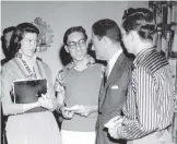  ?? COURTESY OF JUDI SINKS ?? Judi Sinks, known then as Judi Smith, and her Valley High newspaper colleagues Johnny Saiz, center, and James Taylor, right, interview Hollywood impresario Mike Todd in Albuquerqu­e in 1958.