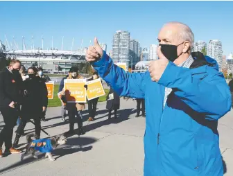  ?? JONATHAN HAywARD/ THE CANADIAN PRESS ?? John Horgan greets supporters on election day in Vancouver.