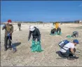  ??  ?? Israel volunteers clean the contaminat­ed HaBonim beach, south the port city of Haifa, on Sonday.