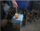  ?? ?? Miroslav Milosevic pours plum brandy into a bottle Nov. 11 in the village of Rozanci, Serbia.