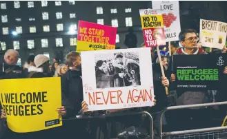  ?? (Reuters) ?? DEMONSTRAT­ORS IN LONDON hold a protest rally yesterday against US President Donald Trump’s executive order banning refugees from seven Muslim countries from entering the US.